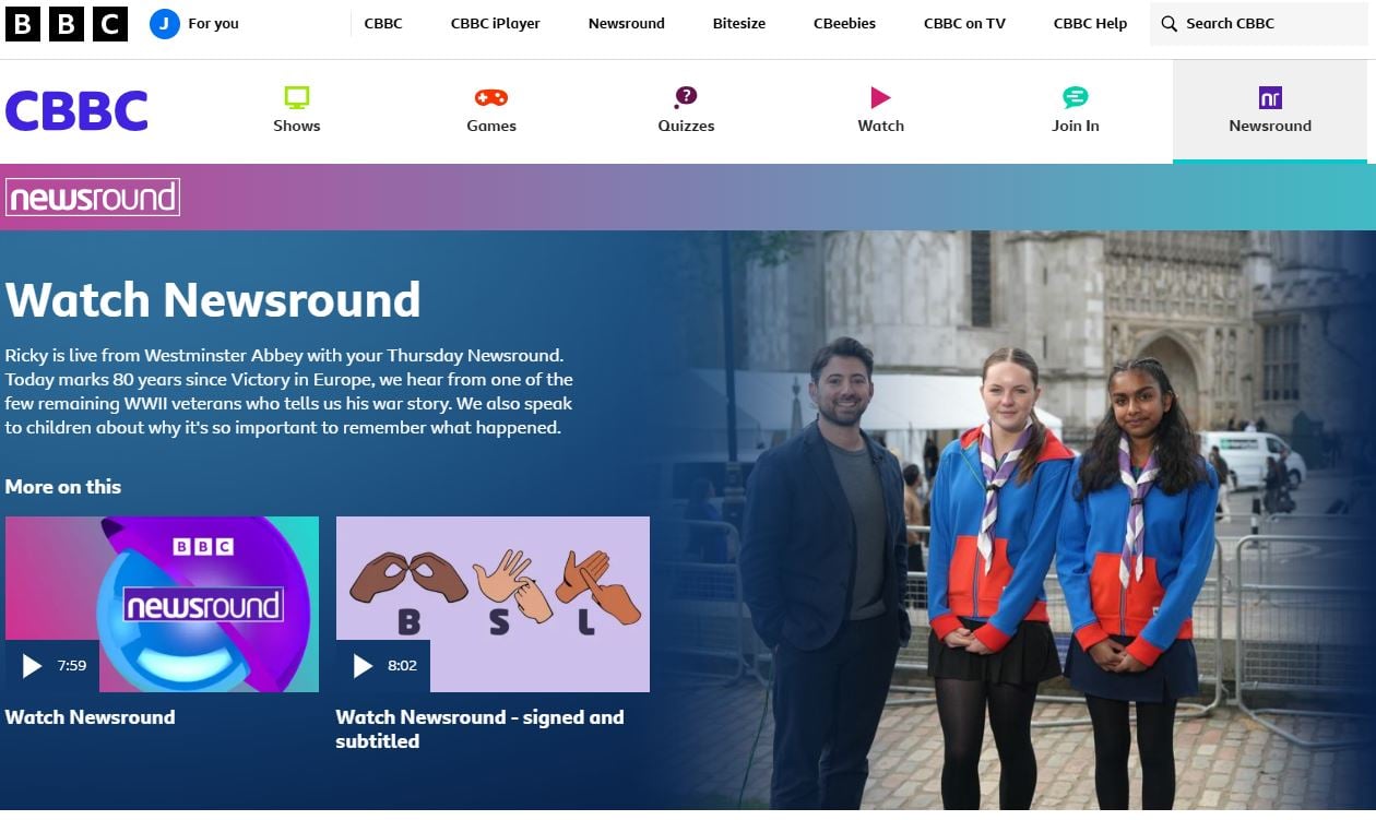 Screenshot of the Newsround homepage which shows an image of two Guides in uniform being interviewed by a presenter in front of Westminster Abbey